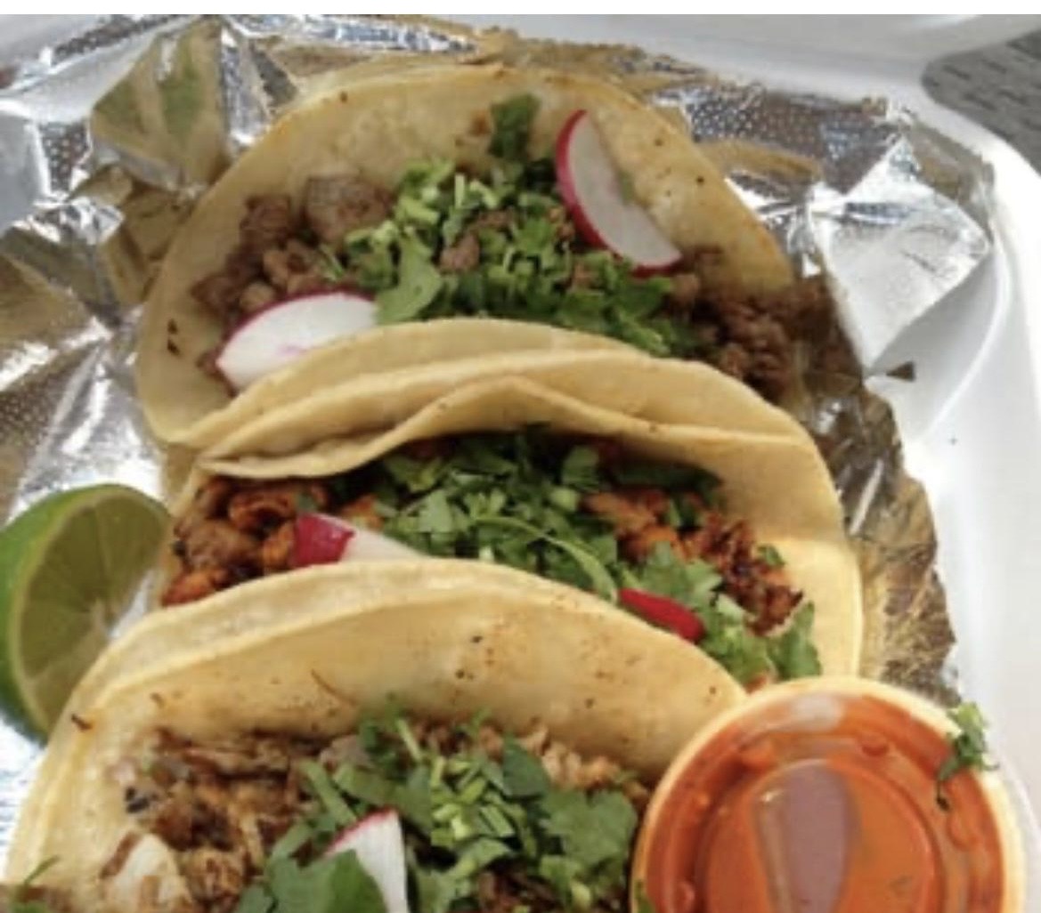 Tacos al pastor topped with pineapple, onion and cilantro
